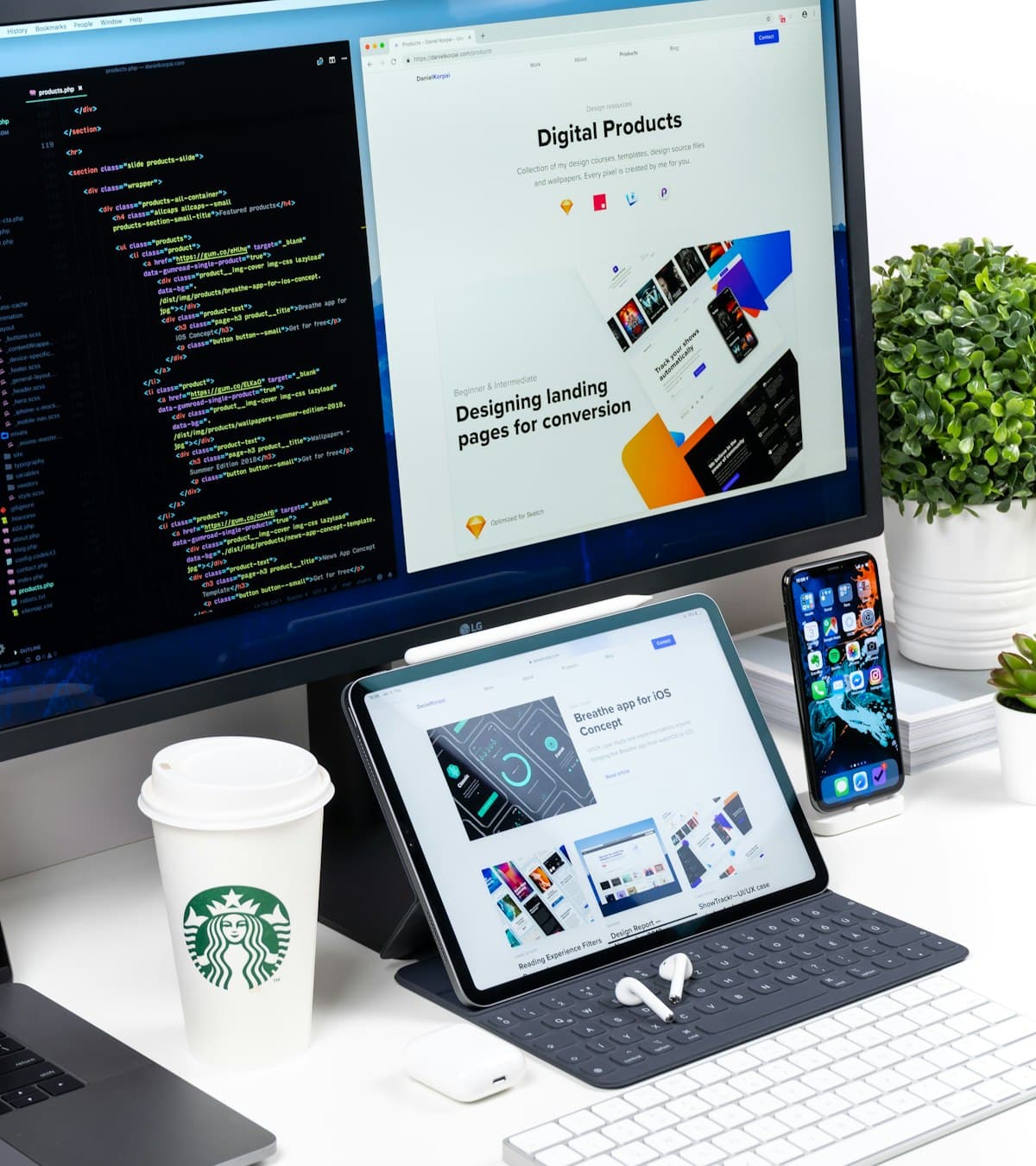 A landing page being designed, open on a monitor, tablet and phone